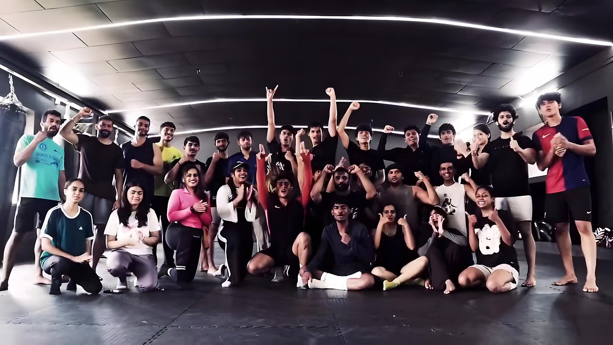 A large group of members posing together on the gym floor