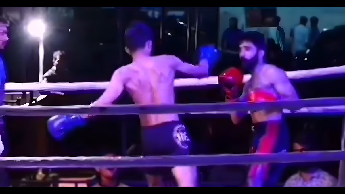 Two Muay Thai fighters exchanging strikes in a ring under stage lights