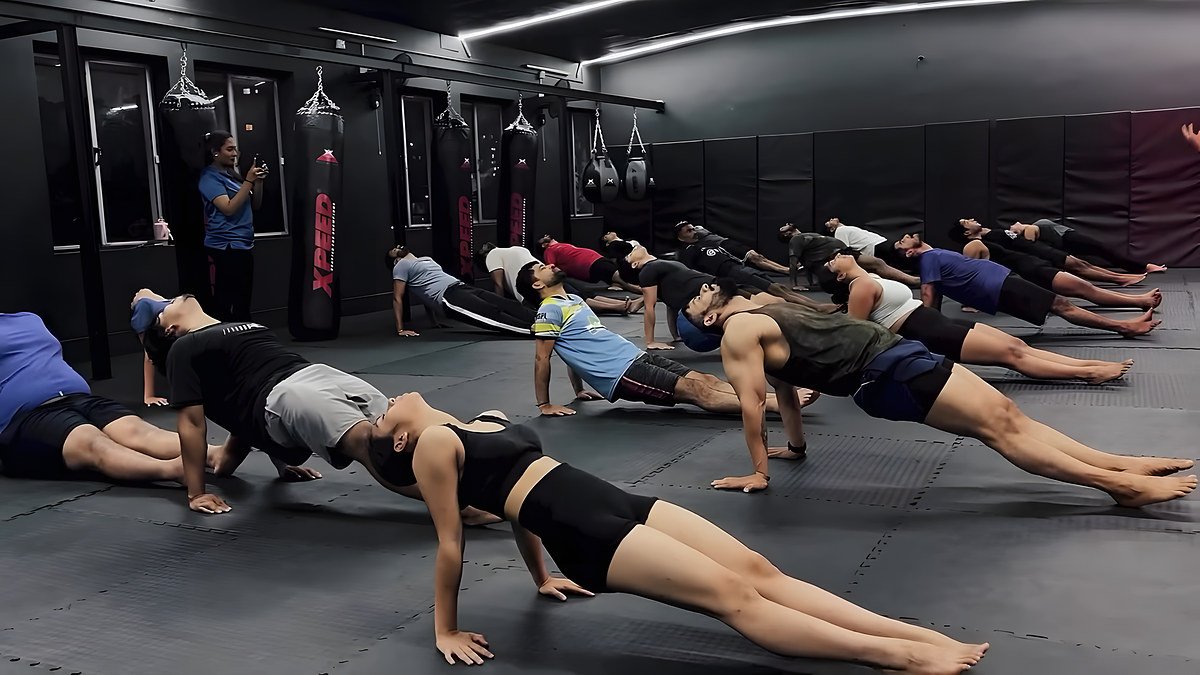 Fighters holding a plank on the mats during a yoga session